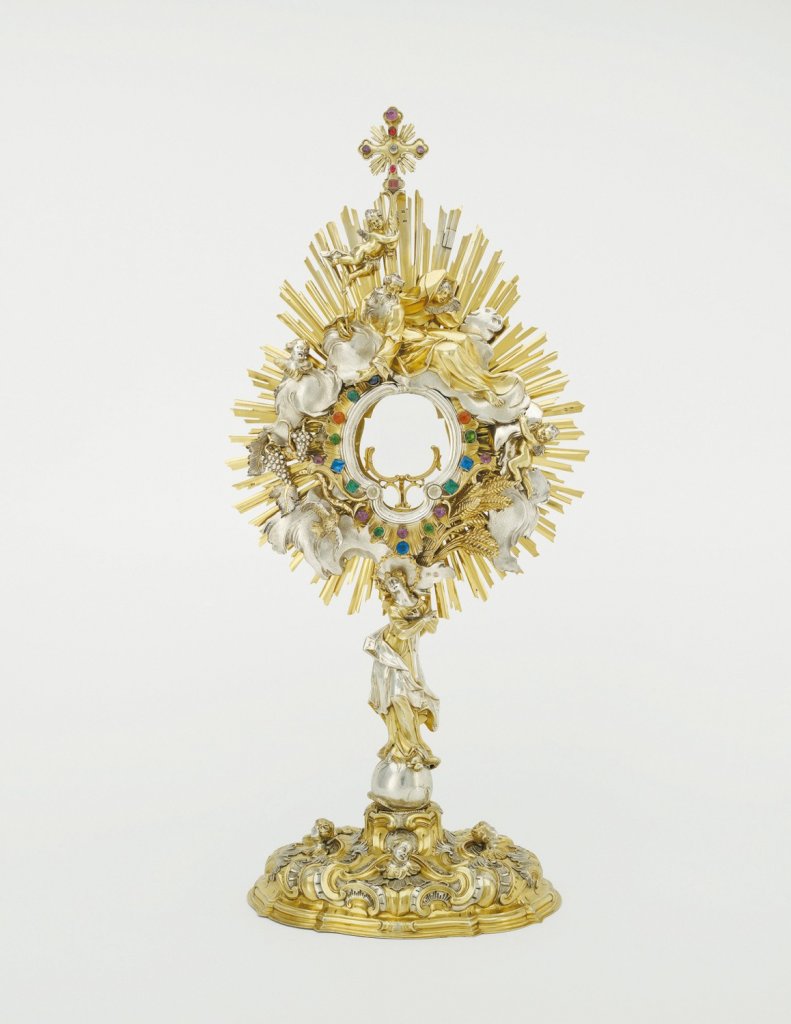 Franz Ignaz Günther – Jan Šimon Forstner, 1751–1752 (návrh), před 1755 (realizace), částečně zlacené stříbro, barevná broušená skla, výška 73.3 cm, šířka koruny 34.2 cm, průměr oválné nohy 22.8×29 cm, Římskokatolická farnost Kopřivnázapůjčeno do stálé expozice Arcidiecézního muzea Olomouc